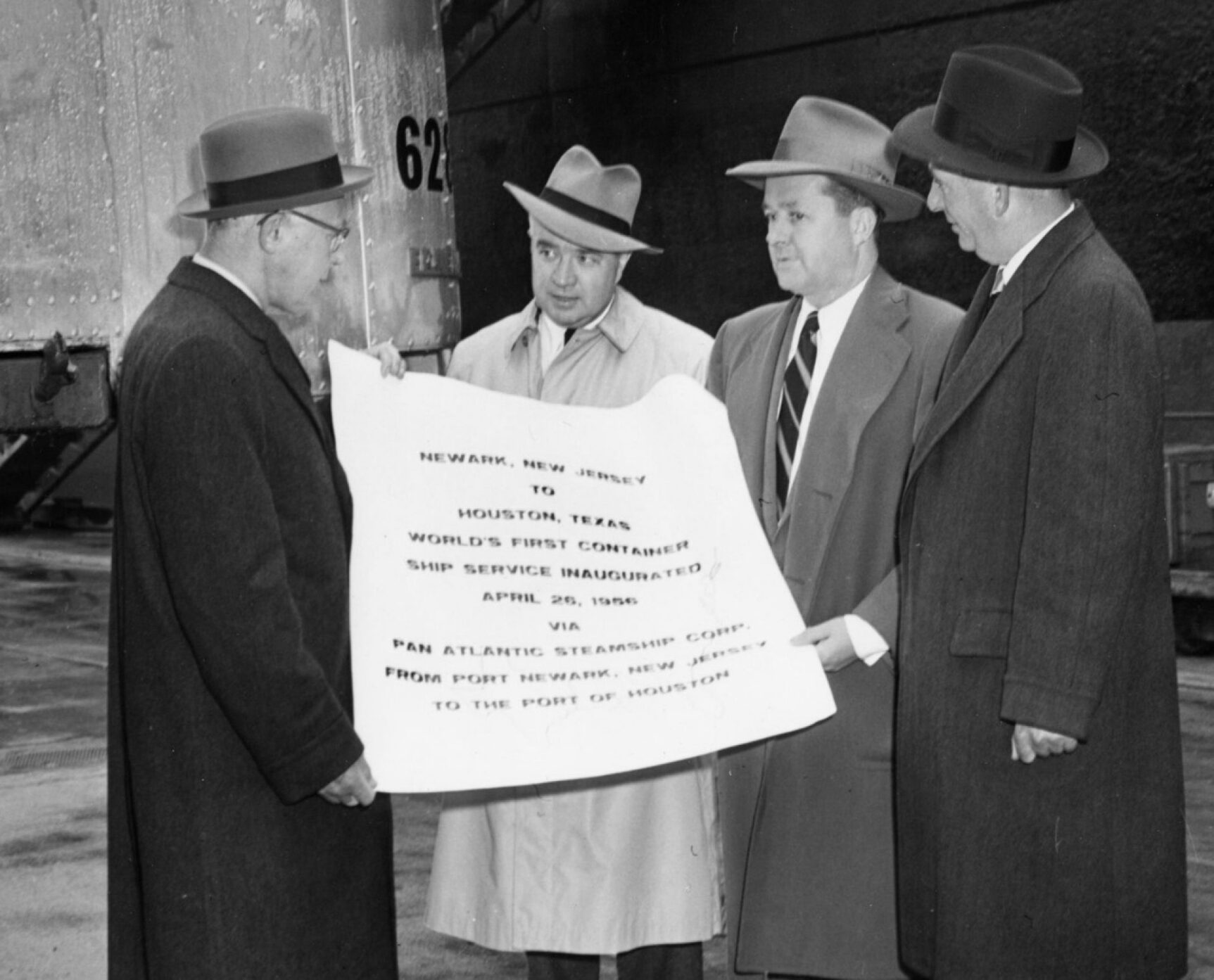 Malcom McLean, right, and other dignitaries marked the world's first container ship service on the shores of Port Newark in April 1956. Courtesy of the Containerization and Intermodal Institute.